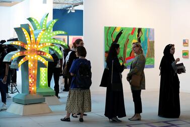 Visitors check out the art work at the Sfeir-Semler Gallery at Abu Dhabi Art at Manarat Al Saadiyat. Pawan Singh / The National