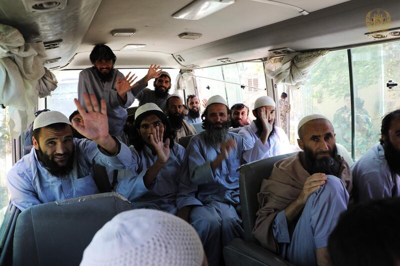 In this handout photograph taken and released on May 25, 2020 by Afghanistan's (NCS) National Security Council, Taliban prisoners wave inside a vehicle during his release from the Bagram prison, next to the US military base in Bagram, some 50 kms north of Kabul.
 Some 100 Taliban prisoners were released from a military prison in Afghanistan on May 25 as part of the government's response to a surprise ceasefire offered by the militants to mark the Eid al-Fitr festival. - RESTRICTED TO EDITORIAL USE - MANDATORY CREDIT "AFP PHOTO / Afghanistan's (NCS) National Security Council " - NO MARKETING NO ADVERTISING CAMPAIGNS - DISTRIBUTED AS A SERVICE TO CLIENTS 
 / AFP / Afghanistan's (NCS) National Security Council / - / RESTRICTED TO EDITORIAL USE - MANDATORY CREDIT "AFP PHOTO / Afghanistan's (NCS) National Security Council " - NO MARKETING NO ADVERTISING CAMPAIGNS - DISTRIBUTED AS A SERVICE TO CLIENTS 
