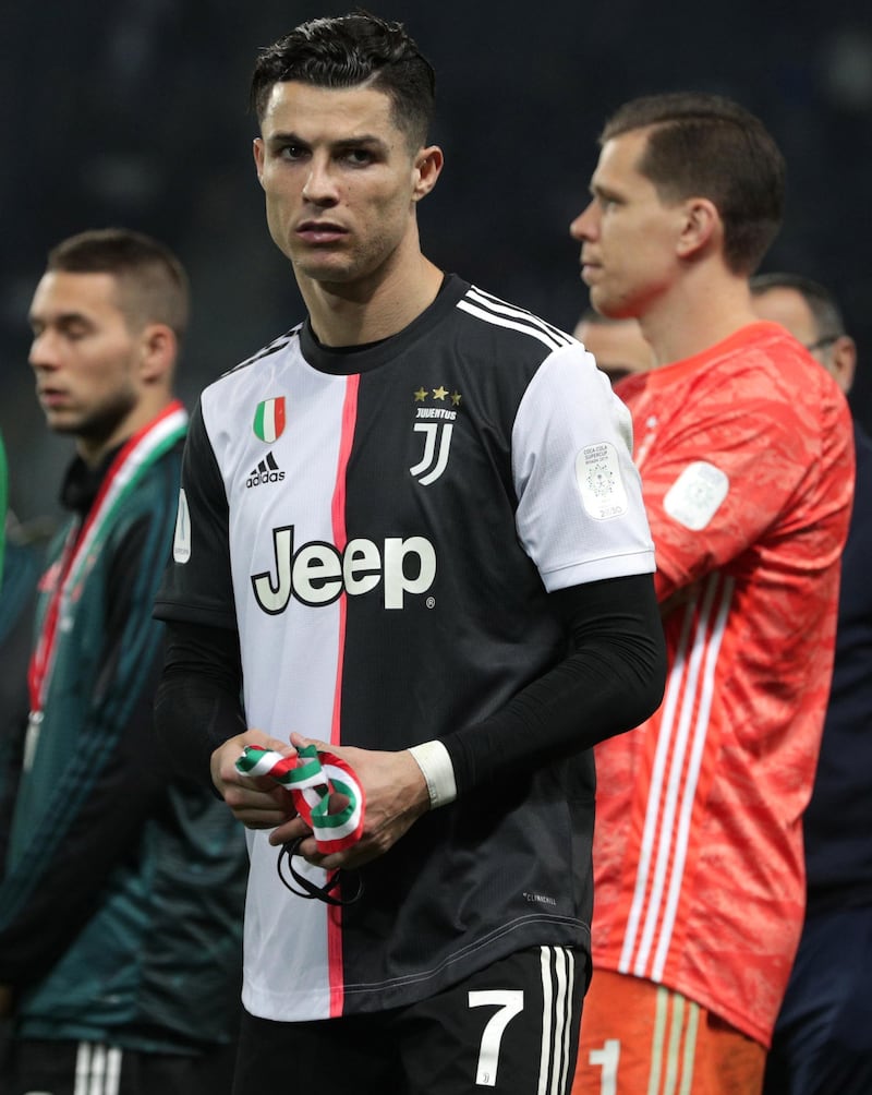 Juventus' Portuguese forward Cristiano Ronaldo takes off his silver medal after losing the Italian Supercup final to Lazio 3-1 Riyadh, Saudi Arabia. AFP