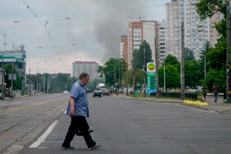 Smoke rises in the background after Russian missile strikes in Kyiv. AP