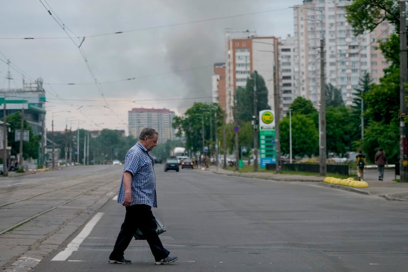 Smoke rises in the background after Russian missile strikes in Kyiv. AP