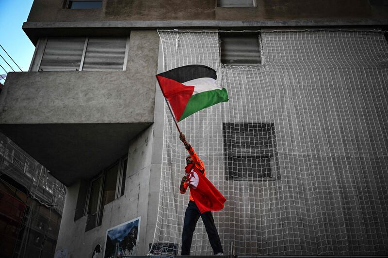 A protester in Lyon, France, waves a Palestinian flag during a rally called by Collectif 69. AFP