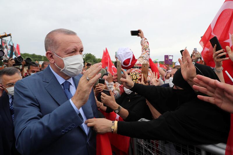 Turkish President Recep Tayyip Erdogan greets his supporters as he arrives at the ground-breaking ceremony of Sazlidere Bridge over the planned route of Istanbul Canal on June 26, 2021. Reuters