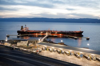 Tanker trucks fill up with crude oil for delivery to the Jordan Petroleum Refinery Co. on the quayside near a crude oil tanker, operated by Navigator Gas LLC, at Aqaba port, operated by Aqaba Development Corp., in Aqaba, Jordan, on Wednesday, April 11, 2018. Both the LNG and the liquefied petroleum gas (LPG) terminals were developed to secure the supply of gas resources after the disruption in Egyptian natural gas imports in 2010. Photographer: Annie Sakkab/Bloomberg