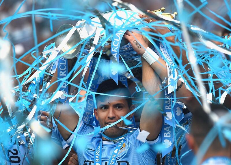 MANCHESTER, ENGLAND - MAY 11:  Sergio Aguero of Manchester City lifts the Premier League trophy at the end of the Barclays Premier League match between Manchester City and West Ham United  at Etihad Stadium on May 11, 2014 in Manchester, England.  (Photo by Shaun Botterill/Getty Images)