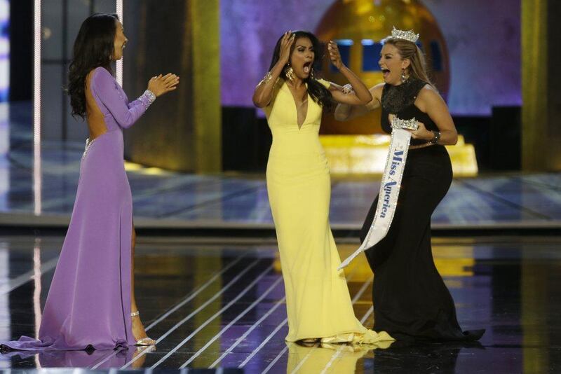 Miss America 2013 Mallory Hagan, right, was denigrated by comments by officials running the competition. AP Photo/Mel Evans