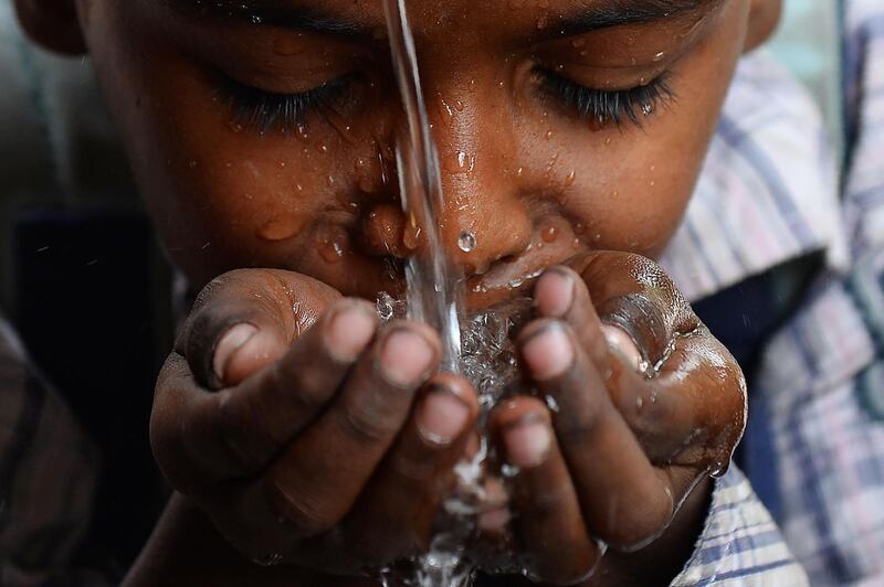 A young boy drinks water on a hot summer day in the old quarters of New Delhi, India, on April 26, 2018. Sajjad Hussain / AFP Photo