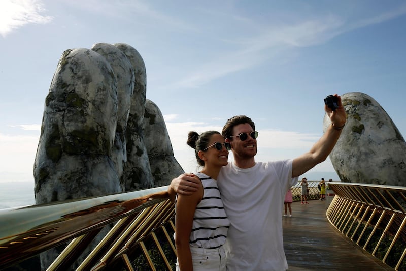 Tourists take a selfie on Vietnam's Golden Bridge on Ba Na hill near Danang city. Reuters