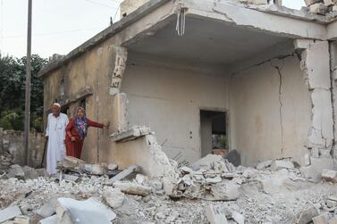 Residents inspect the damage following air strikes on the Syrian town of Muhambal in Idlib province on July 6, 2019. AFP