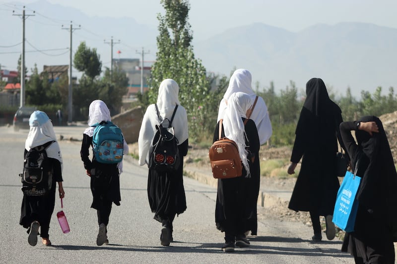 Afghan girls walk to their school along a road in Gardez, Paktia province, on September 8, 2022. AFP