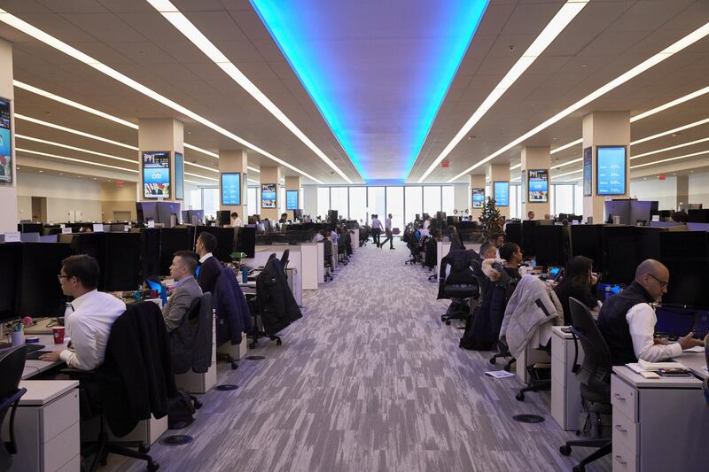 Employees work on the trading floor at the new Citigroup Inc. headquarters in New York, U.S., on Tuesday, Dec. 3, 2019. Citigroup's trading floors - long known for being festooned with flags marking the home countries of its hundreds of traders, and banners touting years of good performance - have gotten swankier, with floor-to-ceiling windows, desks outfitted with 43-inch computer monitors and small cafeterias on every floor. Photographer: Marc McAndrews/Bloomberg