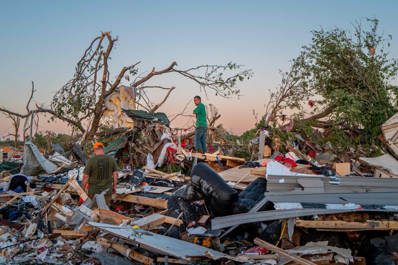 A family rummages through the ruins of their home after it was destroyed by a tornado in Barnsdall, Oklahoma. Getty images