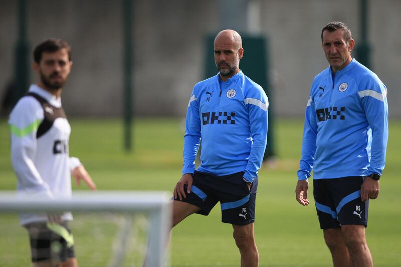 Manchester City manager Pep Guardiola and sports therapist Mark Sertori at training. AFP