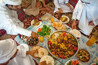 A Middle Eastern Culture family eat together. Dubai, UAE. Getty Images