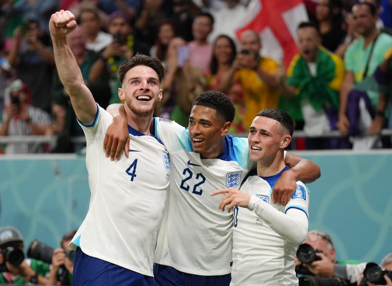 Phil Foden, right, celebrates scoring England's second goal with Jude Bellingham and Declan Rice. PA