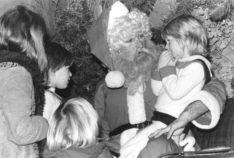 14th December 1978:  Santa Claus in his grotto at Debenhams department store with children gathered around.  (Photo by Evening Standard/Getty Images)