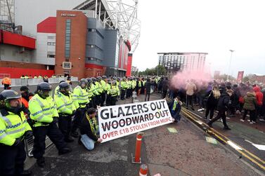 Manchester United fans outside the ground with police presence during a protest against the Glazer family, the owners of Manchester United, ahead of their Premier League match against Liverpool at Old Trafford, Manchester. Picture date: Thursday May 13, 2021. PA Photo. See PA story SOCCER Man Utd. Photo credit should read: Martin Rickett/PA Wire.