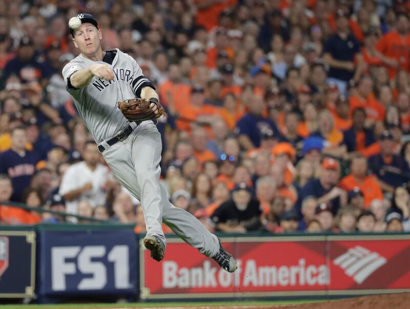 New York Yankees' Todd Frazier plays a ground ball hit by Houston Astros' Alex Bregman during the seventh inning of Game 1 of baseball's American League Championship Series. Bregman beat the throw to first. David J. Phillip / AP Photo.