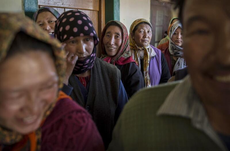 Ladkahi women wait at a polling station to vote near the Thiksey Monastery.