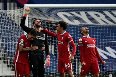 Liverpool's goalkeeper Alisson, second left, celebrates with teammates after scoring his side's second goal during the English Premier League soccer match between West Bromwich Albion and Liverpool at the Hawthorns stadium in West Bromwich, England, Sunday, May 16, 2021. (AP Photo/Rui Vieira, Pool)