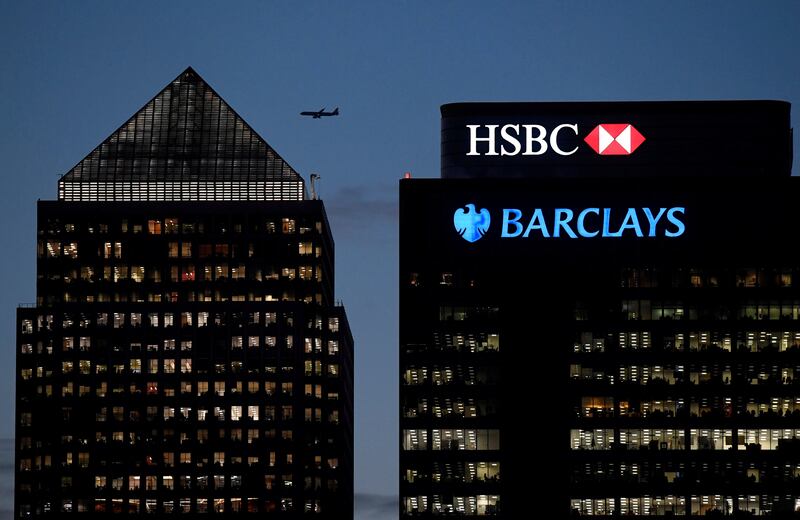 FILE PHOTO: Workers are seen in offices of HSBC and Barclays bank in the Canary Wharf financial district at dusk in London, Britain, November 17, 2017. REUTERS/Toby Melville/File Photo