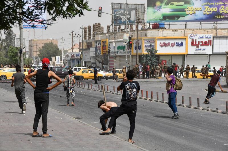 Iraqi protesters hurl stones at security forces amid clashes following an anti-government demonstration in Iraq's southern city of Nasiriyah in Dhi Qar province.  AFP