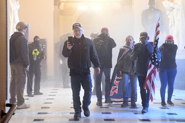 TOPSHOT - Supporters of US President Donald Trump enter the US Capitol as tear gas fills the corridor on January 6, 2021, in Washington, DC. Demonstrators breeched security and entered the Capitol as Congress debated the a 2020 presidential election Electoral Vote Certification. / AFP / Saul LOEB
