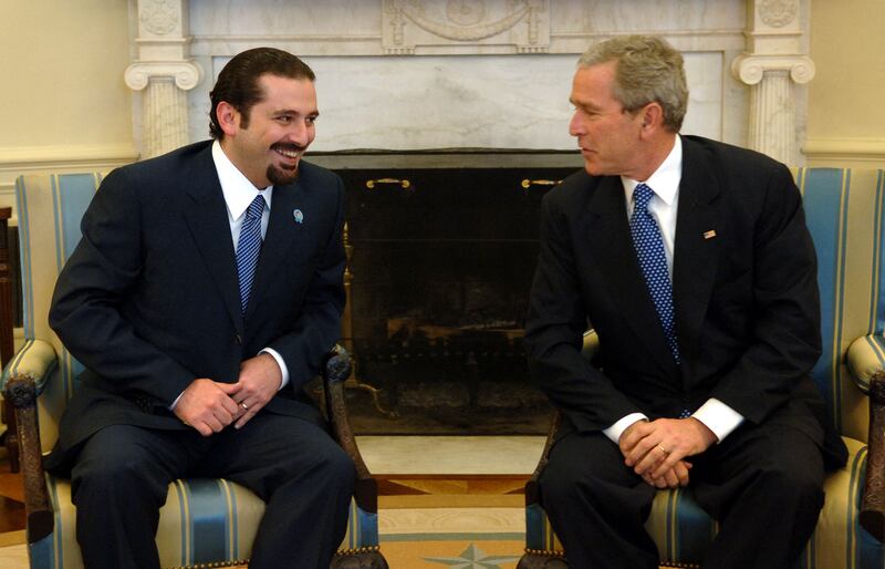 Former US president George W Bush shares a light moment with Mr Hariri during their meeting in the Oval Office of the White House in Washington, in 2006.