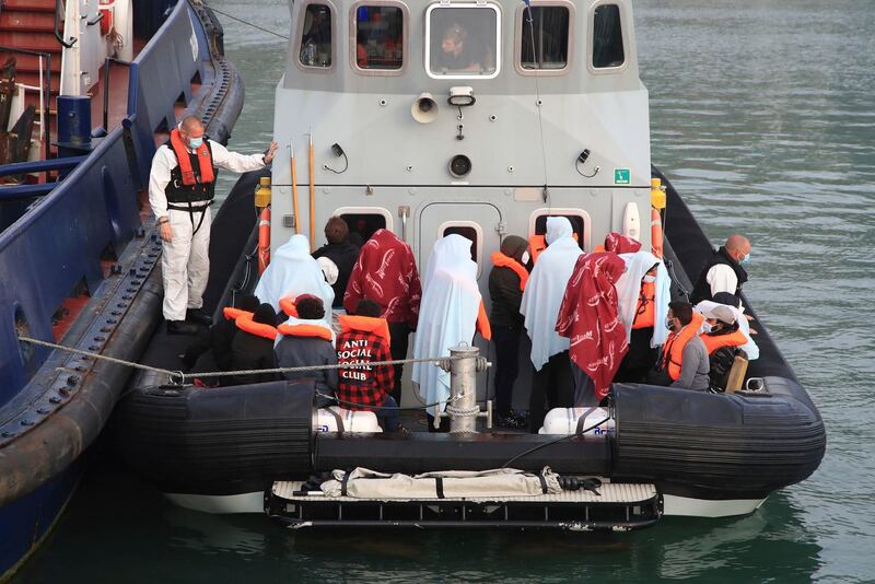 A group of people thought to be migrants are brought in to the harbour in Dover, Kent, England following a small boat incident in the English Channel earlier this morning, Thursday June 3, 2021. (Gareth Fuller/PA via AP)
