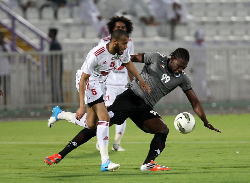 AL AIN , UNITED ARAB EMIRATES Ð Sep 4 :  Makhet ( no 99 in grey ) of Al Dhafra and Yaser ( no 5 in white ) of Sharjah in action during the Pro League round robin tournament football match between Sharjah vs Al Dhafra at Tahnoun Bin Mohammed Stadium in Al Ain. ( Pawan Singh / The National ) For Sports