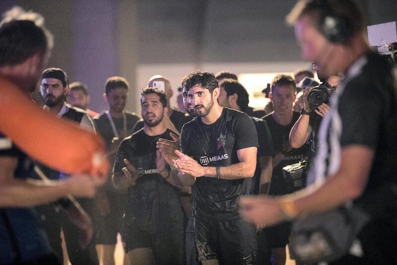 Crown Prince of Dubai, Sheikh Hamdan bin Mohammed, cheers the arriving teams at the finish line on the final day of the Dubai Government Games held at Kite Beach, Dubai. His team, F3, won first place. Reem Mohammed / The National
