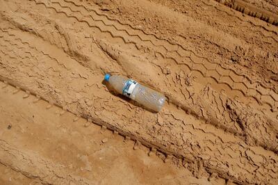 ABU DHABI, UNITED ARAB EMIRATES - August 27, 2009: An empty water bottle lays in the sand in Abu Dhabi. ( Ryan Carter / The National )

*** Stock, Water Project, water *** Local Caption ***  RC005-Water.jpg