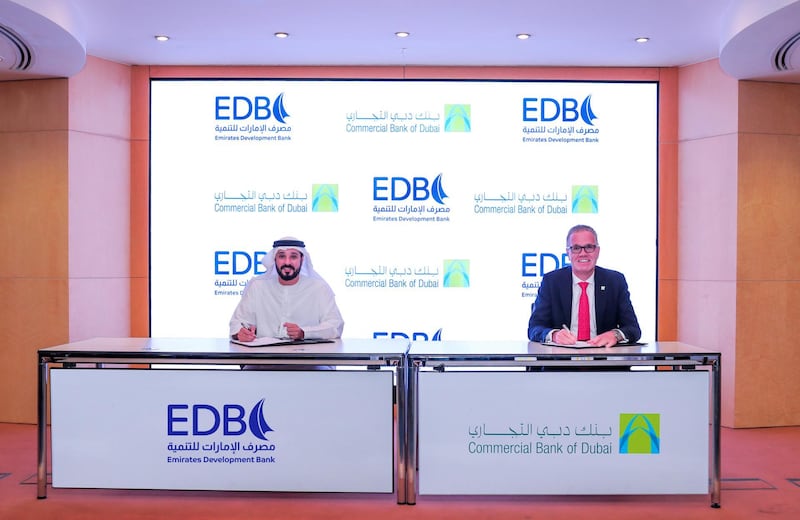 Ahmed Mohamed Al Naqbi, chief executive of Emirates Development Bank, signs a memorandum of understanding with Bernd van Linder, chief executive of Commercial Bank of Dubai, in Abu Dhabi on Wednesday. Courtesy: Emirates Development Bank