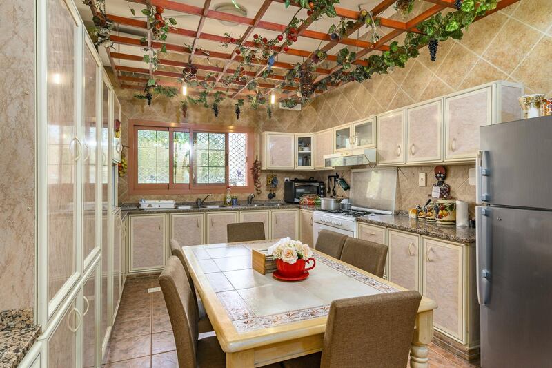 One of the country-style kitchens. Courtesy LuxuryProperty.com