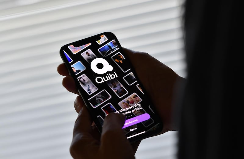 This illustration photo shows a person about to use the Quibi app on a smart phone in Los Angeles, October 21, 2020. Quibi, the short video streaming service launched in April in North America by Jeffrey Katzenberg, a former Disney boss, announced on October 21 the closure and resale of its catalog and other assets because of the pandemic but also because of its business model. / AFP / Chris DELMAS

