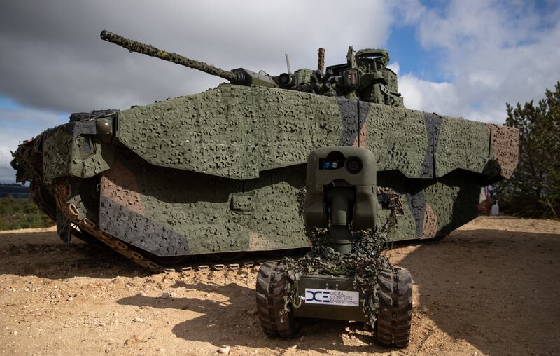 A General Dynamics UK Ajax armoured fighting vehicle and a DCE X series all-terrain unmanned ground vehicle seen at Bovington Camp in Dorset. PA