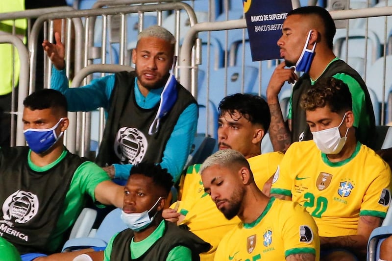 Brazil's Neymar speaks to his teammate Gabriel Jesus as they watch the match. EPA
