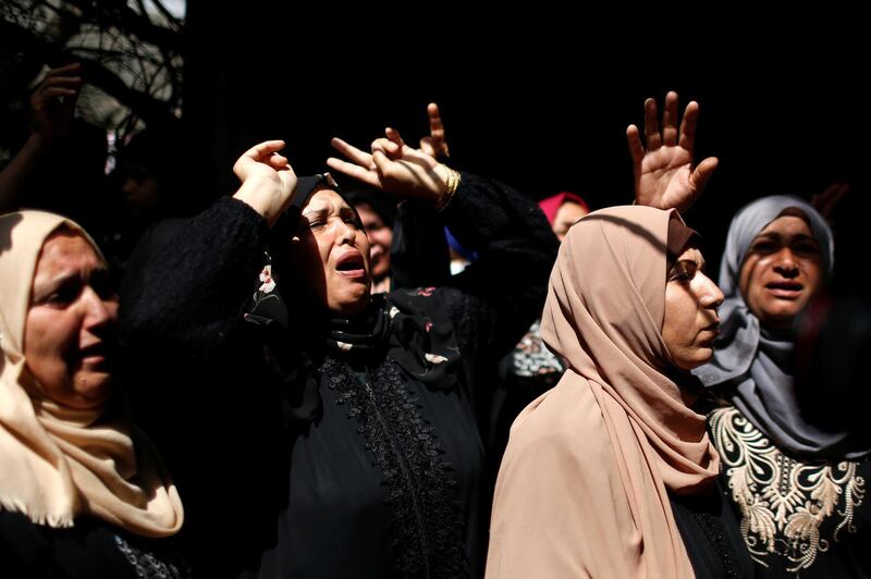 Relatives of Palestinian man Ahmed Al Shenbari, who was killed during recent Palestinian-Israeli violence, react during his funeral in northern Gaza. Reuters