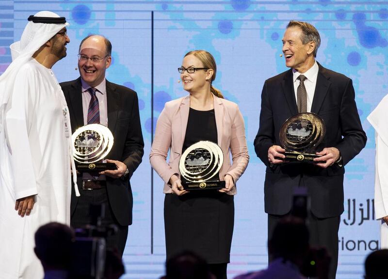 From left: Sultan Al Jaber, Minister of State and Chairman of Masdar, stands with UAE Rain Enhancement Programme award winners Prof Giles Harrison of the University of Reading, Prof Hannele Korhonen of the Finnish meteorological firm FMI, and Dr Paul Lawson of American firm Spec Inc. Christopher Pike / The National