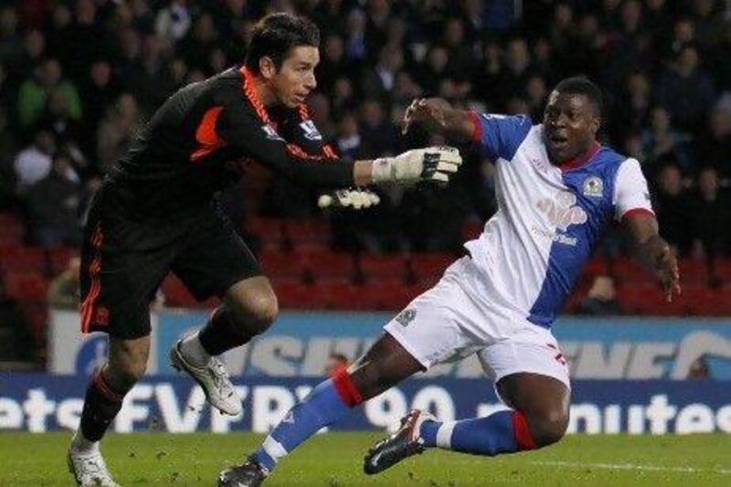 Liverpool's Brad Jones (L) pushes over Blackburn Rovers' Yakubu for a penalty during their English Premier League soccer match at Ewood Park in Blackburn, northern England, April 10, 2012. REUTERS/Darren Staples (BRITAIN - Tags: SPORT SOCCER) FOR EDITORIAL USE ONLY. NOT FOR SALE FOR MARKETING OR ADVERTISING CAMPAIGNS. NO USE WITH UNAUTHORIZED AUDIO, VIDEO, DATA, FIXTURE LISTS, CLUB/LEAGUE LOGOS OR "LIVE" SERVICES. ONLINE IN-MATCH USE LIMITED TO 45 IMAGES, NO VIDEO EMULATION. NO USE IN BETTING, GAMES OR SINGLE CLUB/LEAGUE/PLAYER PUBLICATIONS *** Local Caption *** DST10_SOCCER-ENGLAN_0410_11.JPG