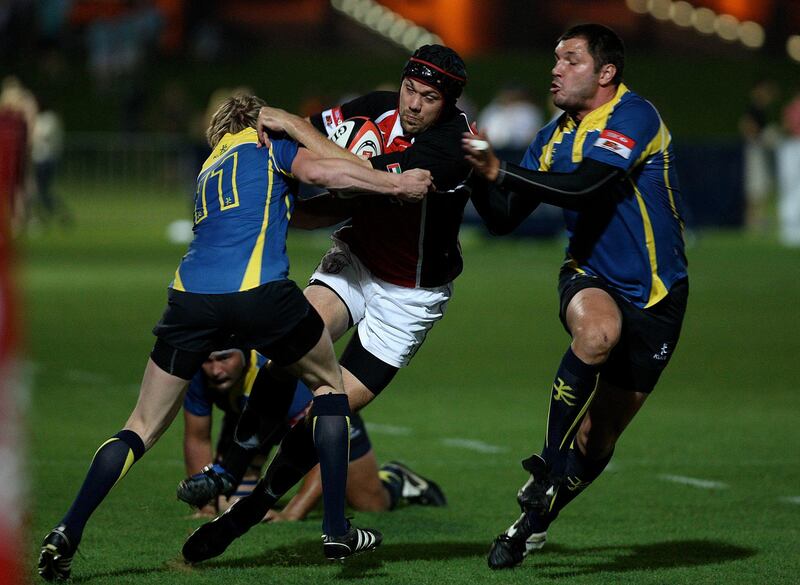 
ABU DHABI, UNITED ARAB EMIRATES Ð April 29,2011: Players of Kazakhstan trying to stop Scott Kerr (center in helmet) of UAE team during the rugby match between UAE vs Kazakhstan at Zayed Sports City Rugby fields in Abu Dhabi. (Pawan Singh / The National) For Sports. Story by Paul