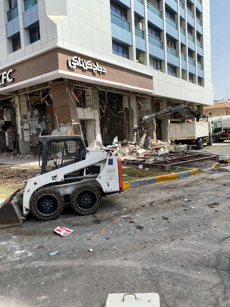 Workers began clearing debris that was flung into the street after the ground floor blast at the KFC and Hardee's outlet. The National