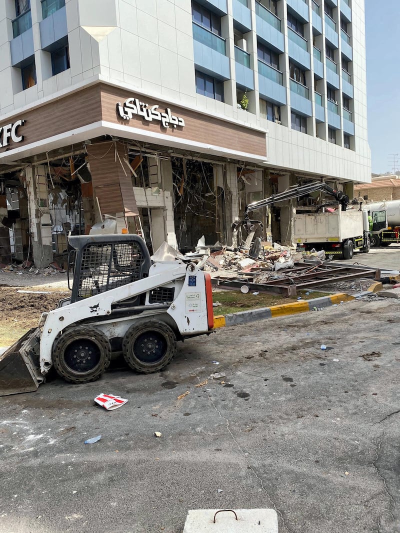 Workers began clearing debris that was flung into the street after the ground floor blast at the KFC and Hardee's outlet. The National