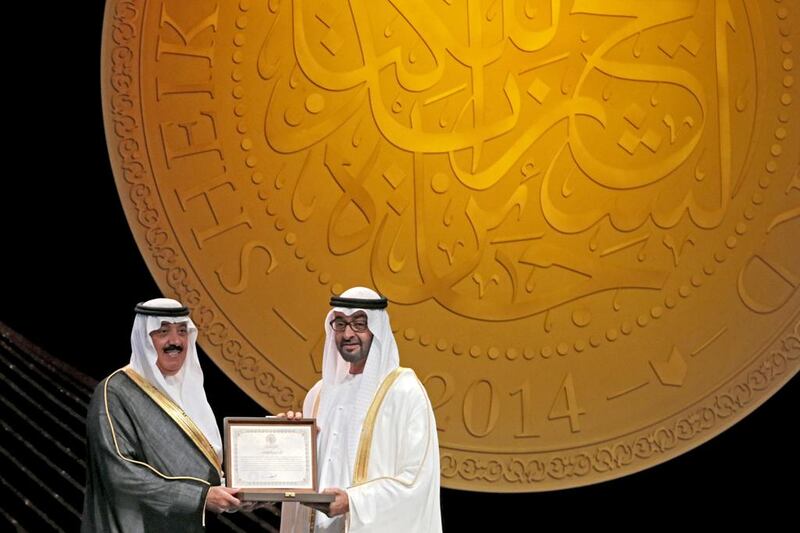 Sheikh Mohammad bin Zayed Al Nahyan, Crown Prince of Abu Dhabi, and deputy supreme commander of the UAE Armed Forces awards the Personality of the Year 2014 to Mutaib bin Abdullah bin Abdulaziz Al Saud, Prince of Saudi Arabia, on behalf of his father Abdullah bin Abdulaziz Al Saud, King of Saudi Arabia, during the Sheikh Zayed Book Awards Ceremony. Christopher Pike / The National