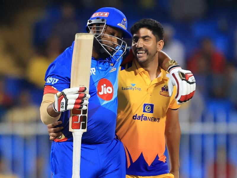 MI Emirates' Kieron Pollard, left, with Sharjah Warriors bowler Junaid Siddique during their DP World International League T20 match at the Sharjah Cricket Stadium on Tuesday, January 17, 2023. AFP