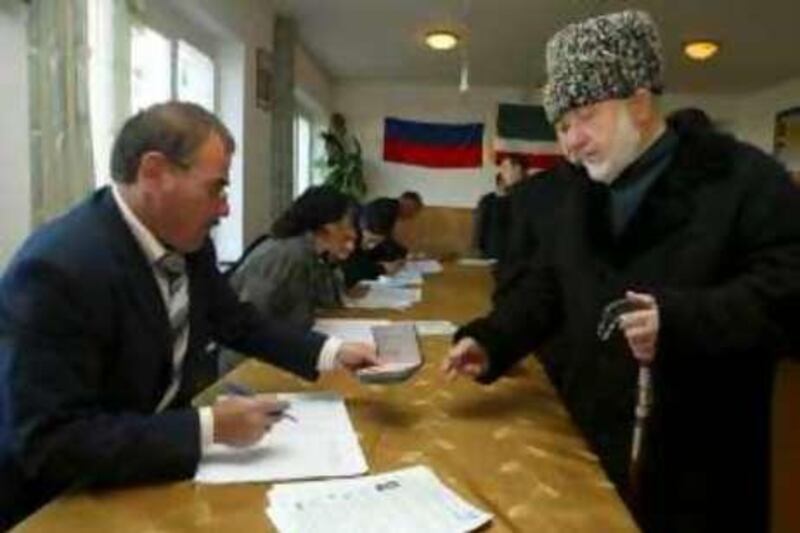 A man picks his ballot papers at a polling station in Tsentoroy settlement, 45 km (28 miles) southeast of Grozny, October 12, 2008. Chechnya is having an election into a local parliament on Sunday.  REUTERS/Said Tsarnayev  (RUSSIA) *** Local Caption ***  TSE02_RUSSIA-_1012_11.JPG