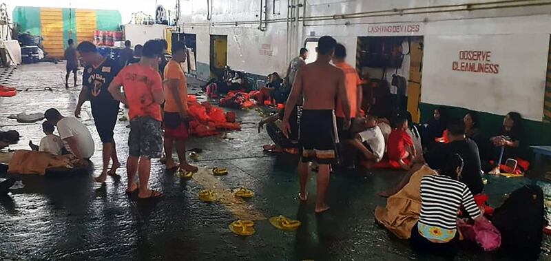 This handout photo released on August 28, 2019 by the Philippine coast Guard (PCG) shows coastguard personnel attending to rescued ferry passengers from Lite Ferry after it caught fire early on August 28 off Dapitan, in southern island of Mindanao, as they rest on board another ferry that helped in rescue operations.  Three people were dead and over 200 rescued in the southern Philippines after a fire tore through a crowded ferry, while an uncertain number remained unaccounted for, authorities said. - --EDITORS NOTE -- RESTRICTED TO EDITORIAL USE MANDATORY CREDIT " AFP PHOTO / Philippine coast Guard (PCG)" NO MARKETING NO ADVERTISING CAMPAIGNS - DISTRIBUTED AS A SERVICE TO CLIENTS - NO ARCHIVES
 / AFP / Philippine coast Guard (PCG) / HO / --EDITORS NOTE -- RESTRICTED TO EDITORIAL USE MANDATORY CREDIT " AFP PHOTO / Philippine coast Guard (PCG)" NO MARKETING NO ADVERTISING CAMPAIGNS - DISTRIBUTED AS A SERVICE TO CLIENTS - NO ARCHIVES
