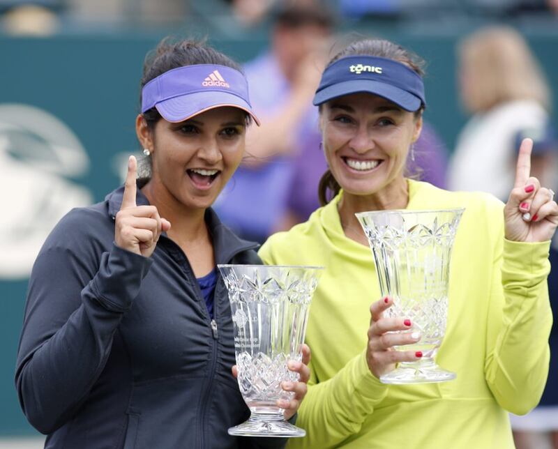 Sania Mirza, left, alongside doubles partner Martina Hingis after winning the Family Circle Cup in 2015 that propelled her to No1 in doubles rankings. AP