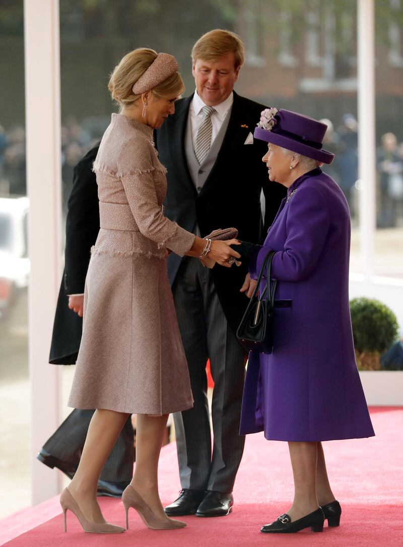 Britain's Queen Elizabeth greets King Willem-Alexander and his wife Queen Maxima of the Netherlands at a Ceremonial Welcome during a state visit. Matt Dunham / AFP