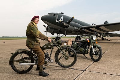 DUXFORD, ENGLAND - May 21:  A member of the Living History reenactment group poses with both the original Royal Enfield Flying Flea motorcycle and the 'Classic 500 Pegasus' motorcycle at IWM Duxford on May 21, 2018 in Duxford, England.  A new limited edition Royal Enfield 'Classic 500 Pegasus' motorcycle pays tribute to the original Royal Enfield Flying Flea, the legendary lightweight World War Two British paratroopers' motorcycle.  (Photo by Ian Gavan/Getty Images for Royal Enfield)